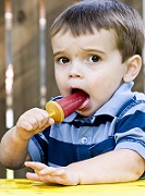 boy eating popsicl